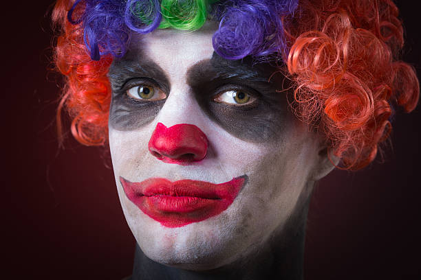 istock Evil Spooky Clown Portrait on dark background. expressive man 496386202