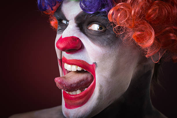 istock Evil Spooky Clown Portrait on dark background. expressive man 496386268