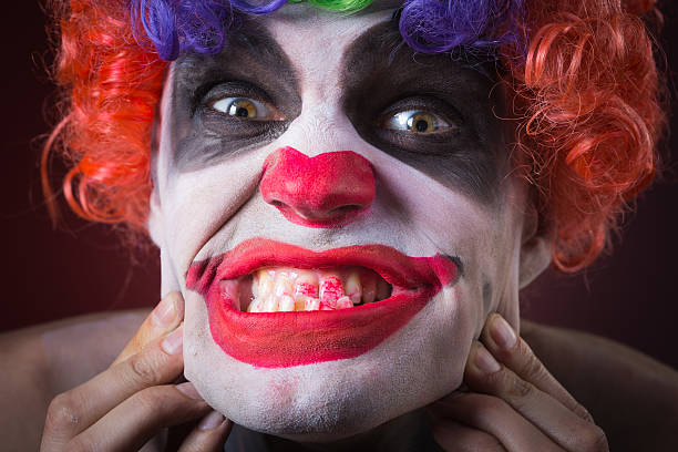 istock Evil Spooky Clown Portrait on dark background. expressive man 496386314