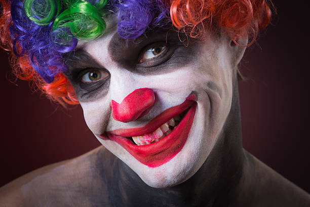 istock Evil Spooky Clown Portrait on dark background. expressive man 496386330