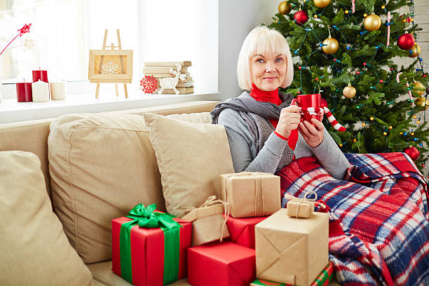 istock Pretty mature woman by Christmas tree 496387108