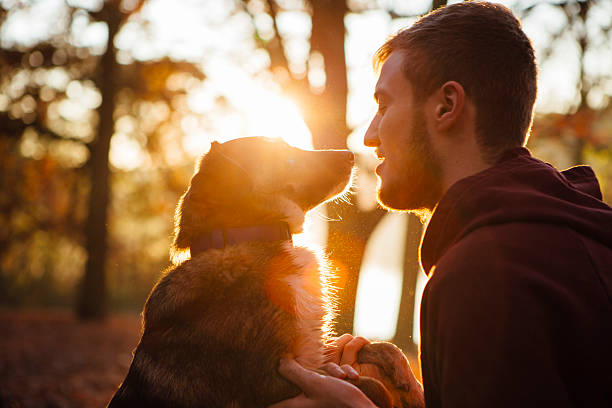 istock young man with his small Mixed-breed dog 496387176