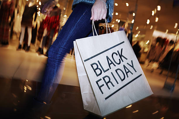 Visiting mall on Black Friday Modern shopper with Black Friday paperbag going in the mall spree river photos stock pictures, royalty-free photos & images