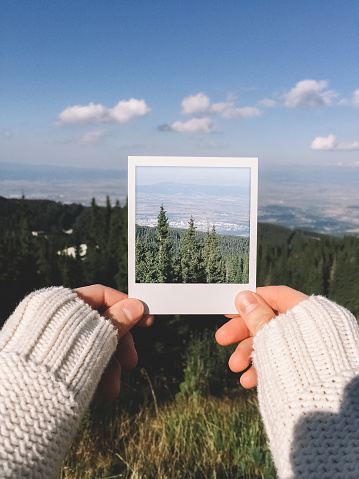 Showing a polaroid photo of mountains.Mobilestock photo