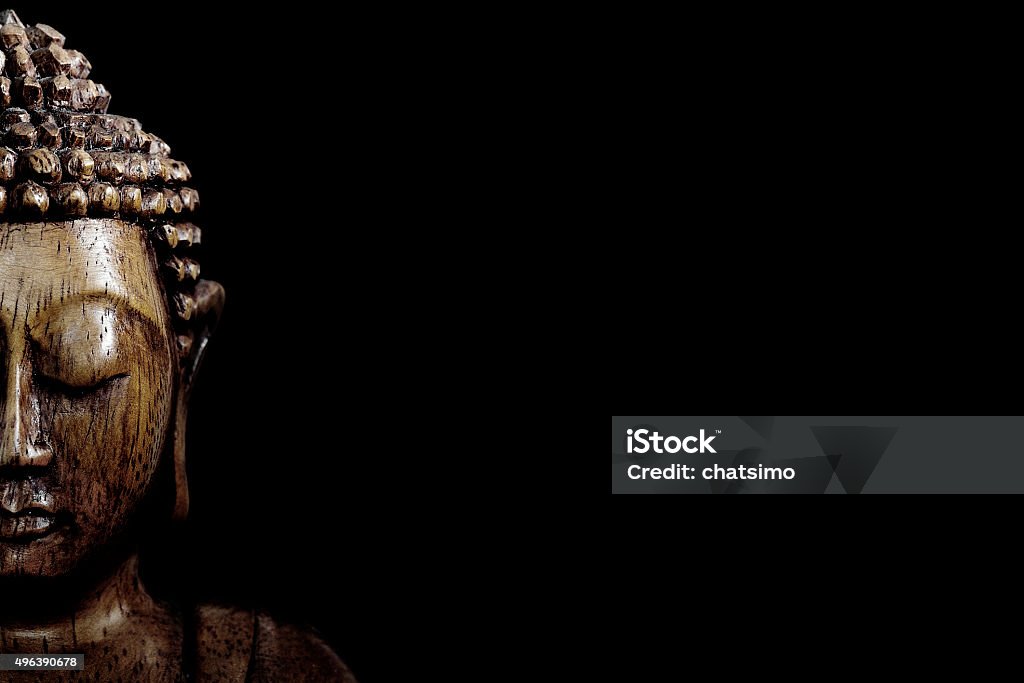 Wooden buddha statue Wooden buddha statue on table shot in studio Buddha Stock Photo