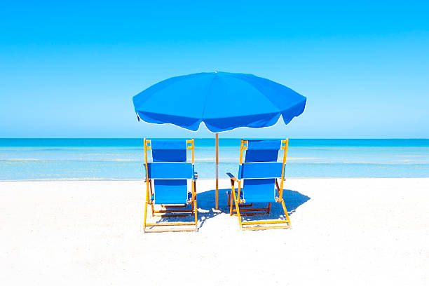 istock Lounge Chairs and Umbrella at the Beach 496395989