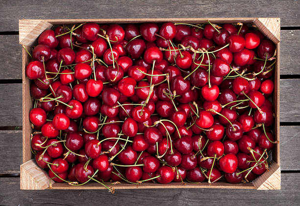 Box of cherries Wooden box of fresh cherries vitamin rich stock pictures, royalty-free photos & images