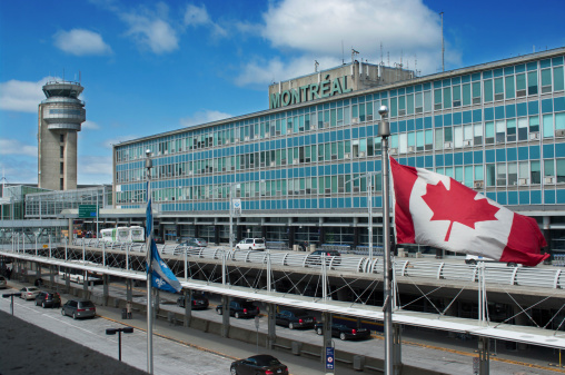 Montreal, Quebec, Canada - April 16 2014: Montreal International Airport building.  Airport is named in honor of Pierre Elliott Trudeau, the 15th Prime Minister of Canada.