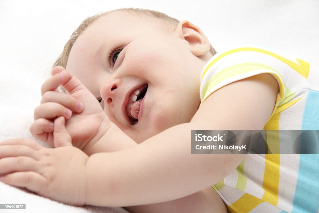 Happy baby lying in bed Happy little baby lying in bed 12-17 Months Stock Photo