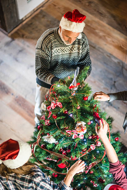 istock grandparent making the christmas tree 496406694
