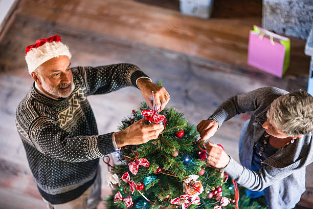 istock grandparent making the christmas tree 496407316