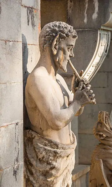 Ancient Sculpture Satire (PAN) plays the flute