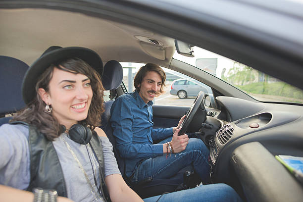 istock Couple having fun driving car 496408140