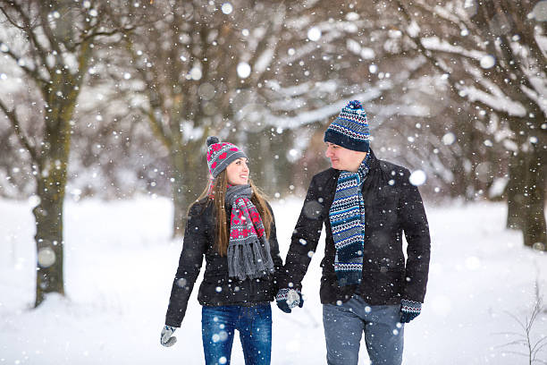 istock loving couple walking in winter park 496409644