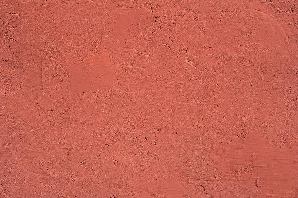 istock Texture of old wall covered with red stucco 496409820