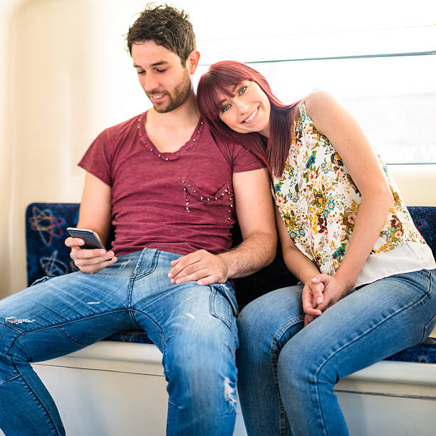 istock tired couple traveling on public transportation 496410370