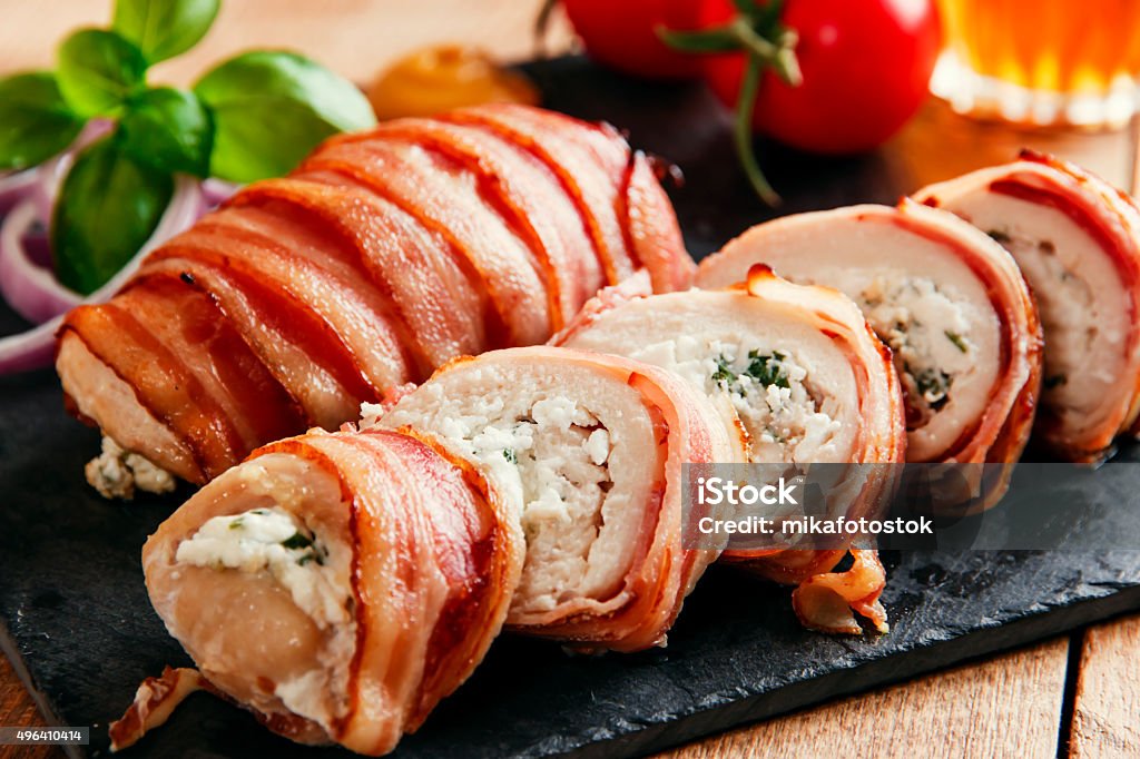 chicken breast stuffed  feta cheese and herbs wrapped in bacon chicken breast stuffed  feta cheese and herbs wrapped in bacon  Bacon Stock Photo