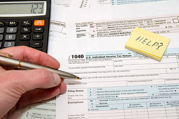 istock Tax Form 1040, U.S.  with calculator and pen 496410904