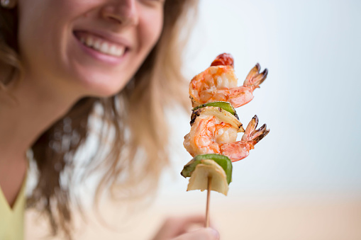 Eating seafood with woman in the background, selective focus 
