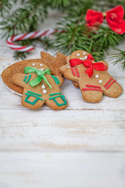 istock Christmas gingerbread cookie couple on white wooden board 496411424