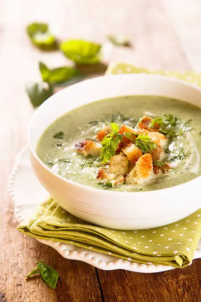 Spinach and basil soup in white bowl