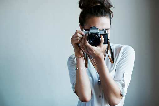 Cropped shot of a young woman taking a photo with a vintage camerahttp://195.154.178.81/DATA/i_collage/pu/shoots/805862.jpg