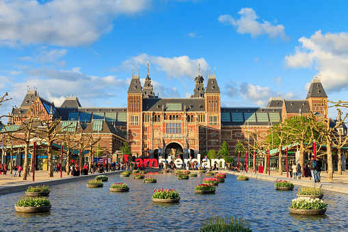 Amsterdam, The Netherlands - May 2, 2014: Beautiful vibrant spring view of tourists at the Rijksmuseum in Amsterdam on May 2, 2014