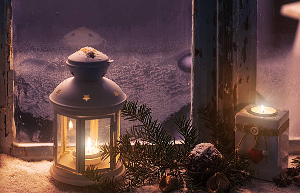 istock Christmas - candles glow in the steamy window 496416106