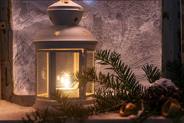 istock Christmas - candles glow in the steamy window 496416142