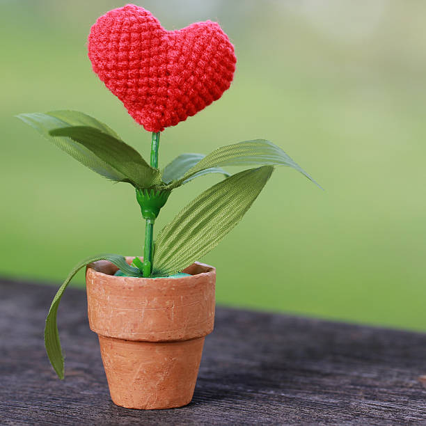 istock Valentines Day background with crochet heart on green background. 496416288