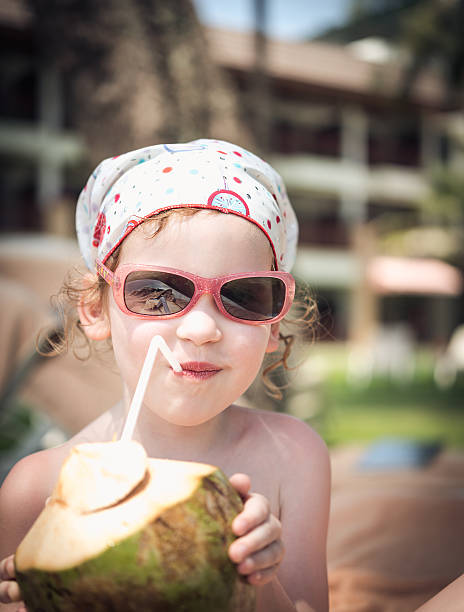 istock Girl with coconut on beach 496416768