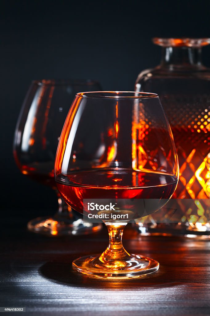 Snifter with brandy Snifter with brandy on black wooden table 2015 Stock Photo