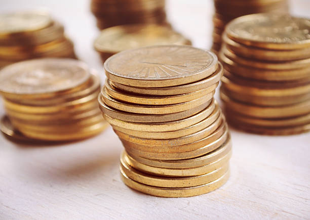 istock Coins On Wooden Table, close up 496429538