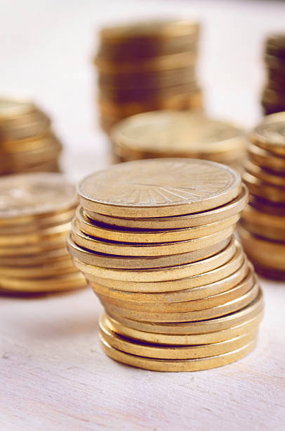 istock Coins On Wooden Table, close up 496429612