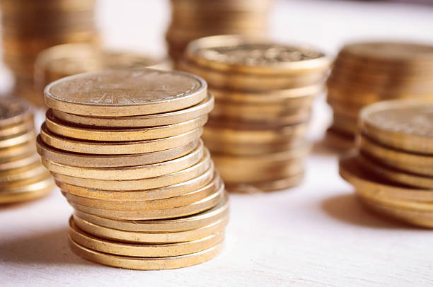 istock Coins On Wooden Table, close up 496429782