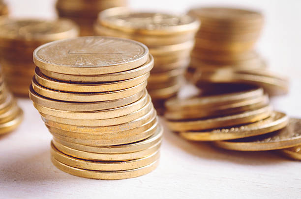 istock Coins On Wooden Table, close up 496429868