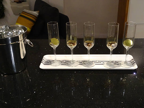 istock Image of five wine-glasses, silver wine bucket on granite counter 496432068