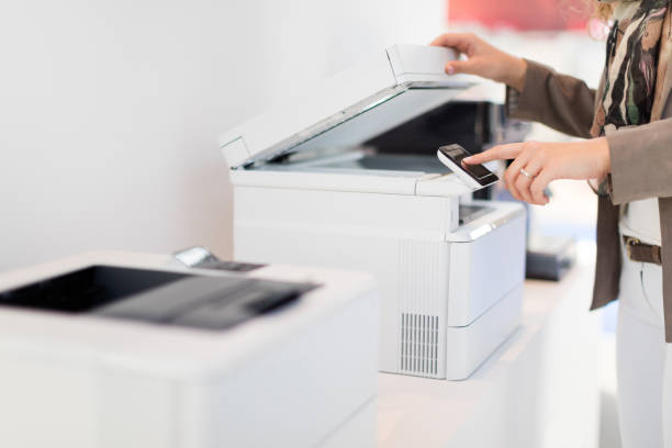 Using copy machine Unrecognizable woman making copies in office computer printer stock pictures, royalty-free photos & images