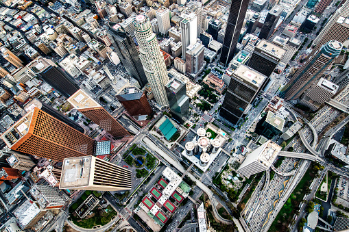 Helicopter point of view of Los Angeles skyscrapers and streets viewed directly from above. Many details are visible in the image.