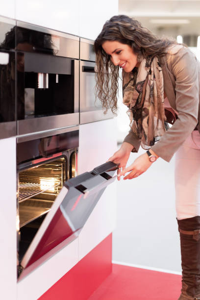 istock Woman choosing oven in store 496434896