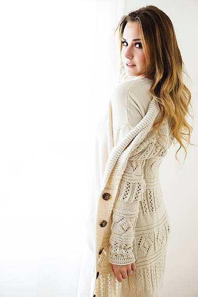 istock Sensual young fashion model posing in white sweater 496435670