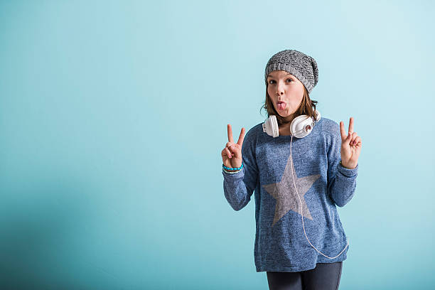 istock Cheaky girl giving victory sign 496436674