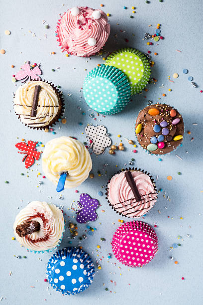 istock Vibrant cupcakes on blue background, party food concept 496436800