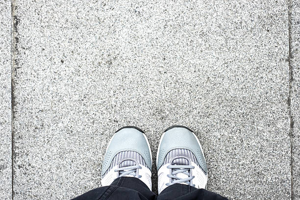 istock top view ,Foot stand on stone pavement floor 496440042