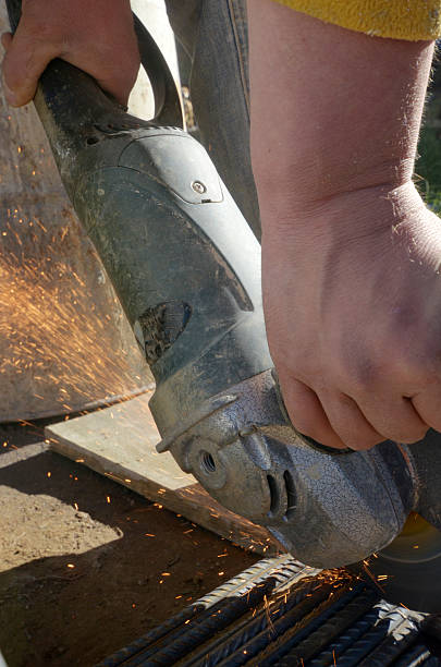 istock Worker cutting metal with grinder withs parks while grinding iron 496440480