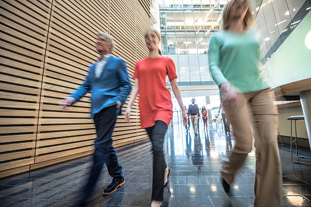 istock Business people walking in modern office, blurred motion 496440742