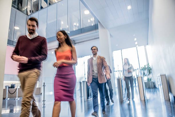 istock Business people walking in modern office, blurred motion 496441460