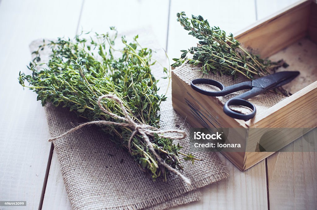 Rustic kitchen still life Rustic home kitchen still life, dried herbs, old boxes and vintage scissors on a wooden table. Backgrounds Stock Photo