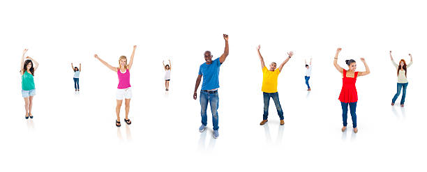 istock Multiethnic Group of People with their Arms Raised 496443209