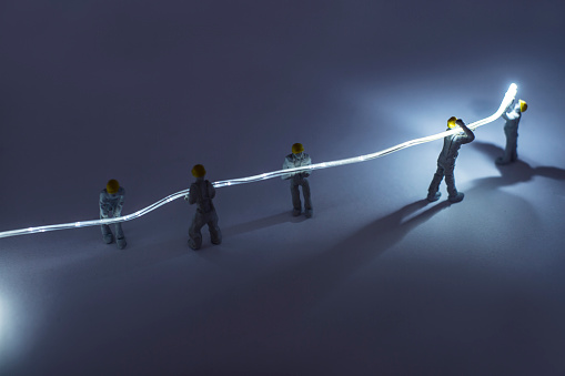 Figurine construction workers, installing fibre optic cables